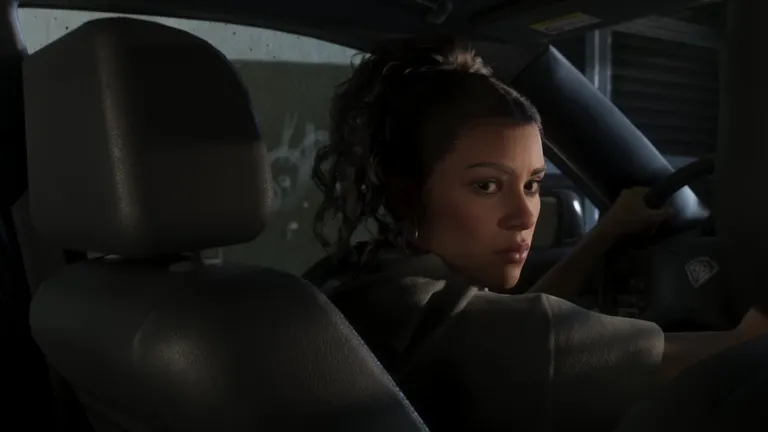 Lucia at the wheel looking back over her shoulder during the chase