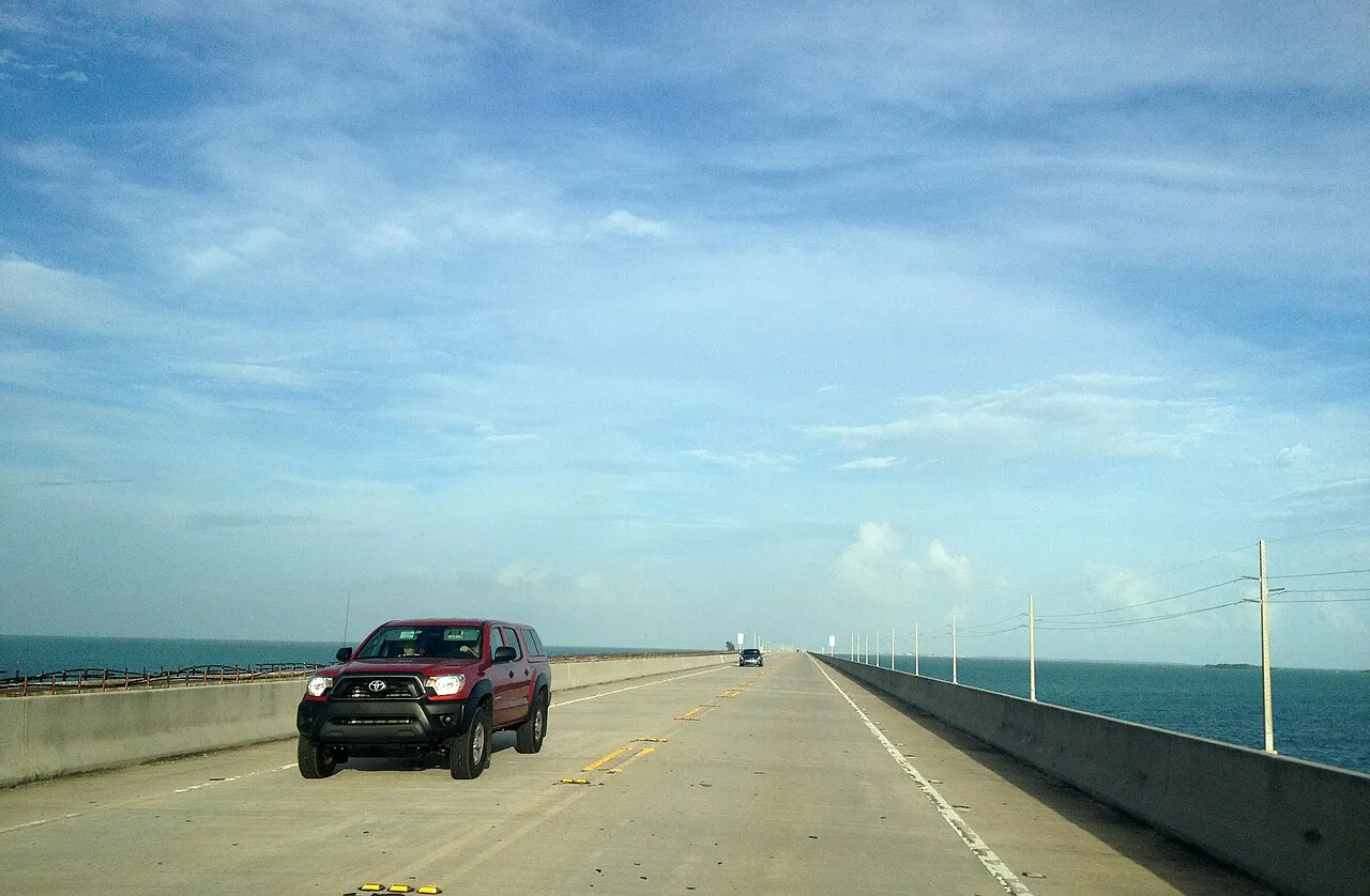 Rockstar's own illustration of Leonida is a low causeway running out over calm water. That is the Overseas Highway, here at the Seven Mile Bridge, the road that carries US-1 across open sea to Key West.